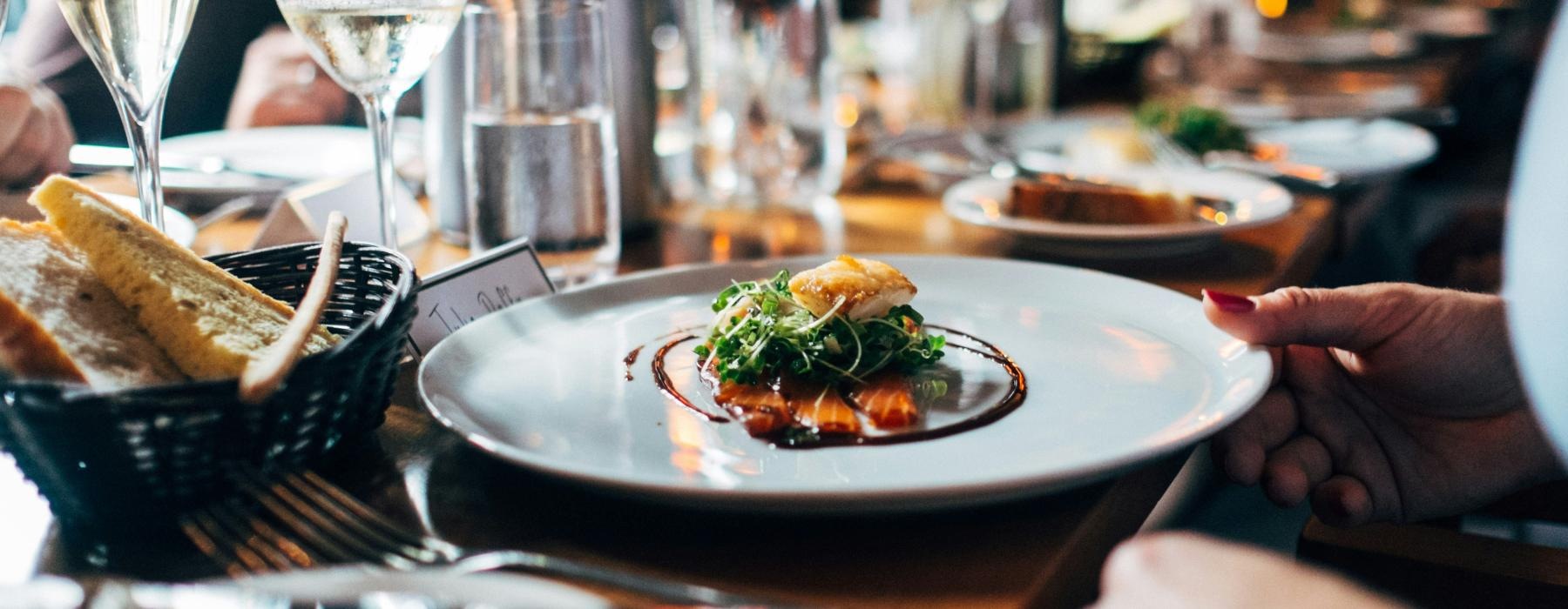 a table with plates of food and glasses of wine