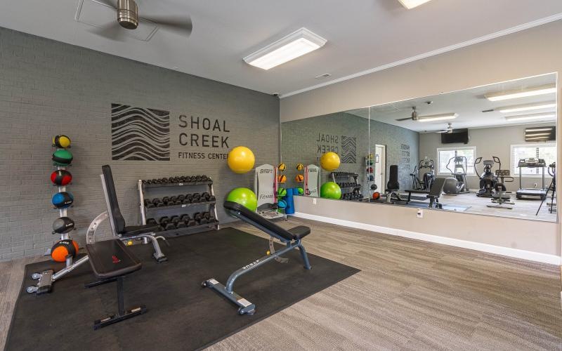 a room with exercise equipment and balloons
