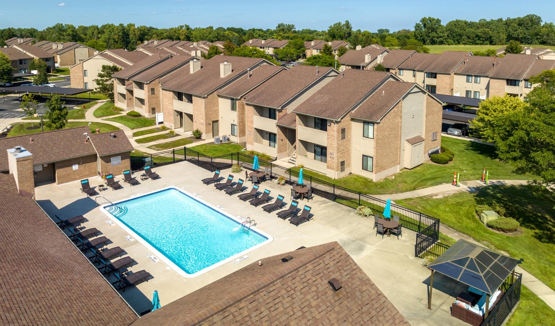Shimmering resort-style pool a swimming pool surrounded by houses