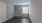 a room with a wood floor and white walls
